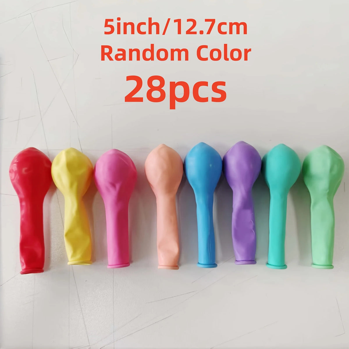 A row of 28 random color latex balloons, 5 inches in size, displayed on a white surface.