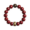 A bracelet made of polished red cinnabar stones with a gold-colored clasp.
