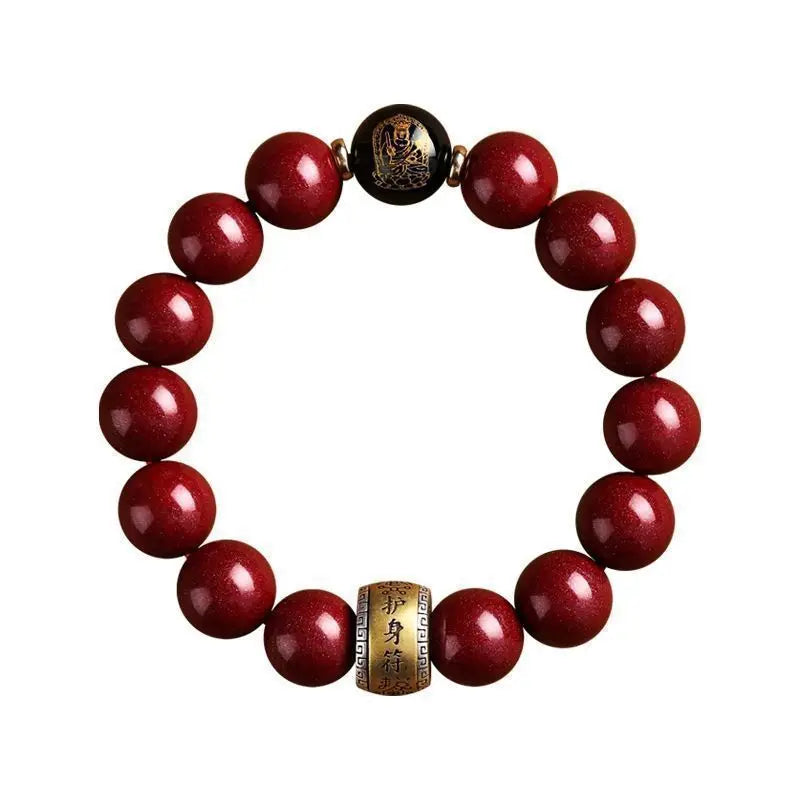 A bracelet made of polished red cinnabar stones with a gold-colored clasp.