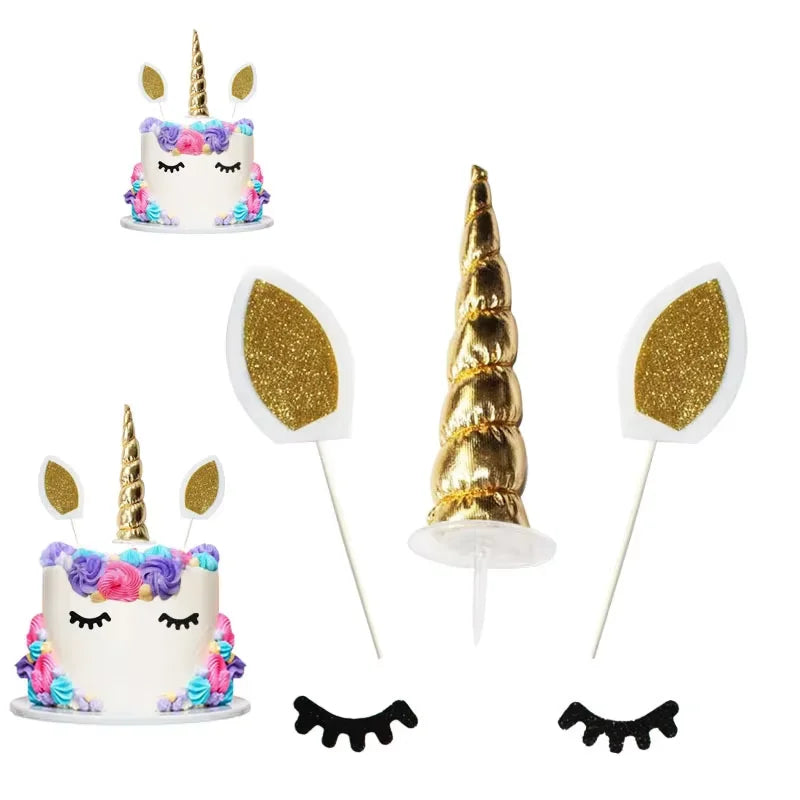Unicorn cake decoration set featuring a tiered cake, horn, flowers, stars, and balls.