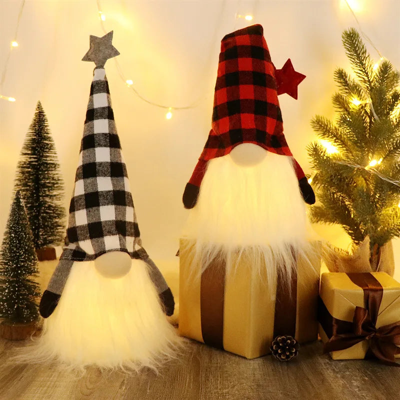 An illuminated LED gnome Christmas decoration with a plaid hat and white beard sitting on a yellow gift box.