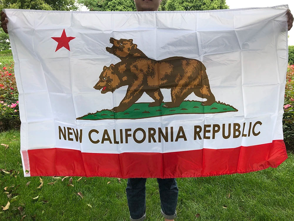 A white flag featuring a brown bear silhouette on a green hill and red star, with the text NEW CALIFORNIA REPUBLIC below.