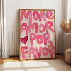 Abstract canvas wall art featuring the pink text MORE AMOR POR FAVOR on a light background.