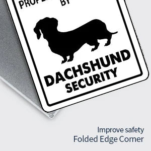 A black silhouette of a Dachshund dog on a white sign with the text DACHSHUND SECURITY.