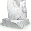 A square marble peel-and-stick wall panel featuring white marble with gold veining stacked on a white surface.