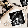 Black and white Halloween themed paper napkins featuring skulls, bats, and a raven silhouette