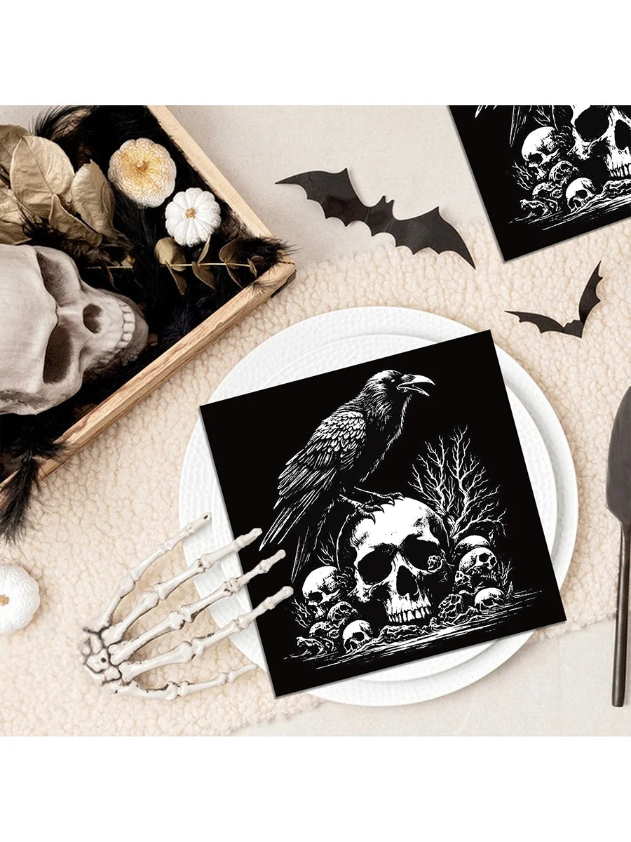 Black and white Halloween themed paper napkins featuring skulls, bats, and a raven silhouette