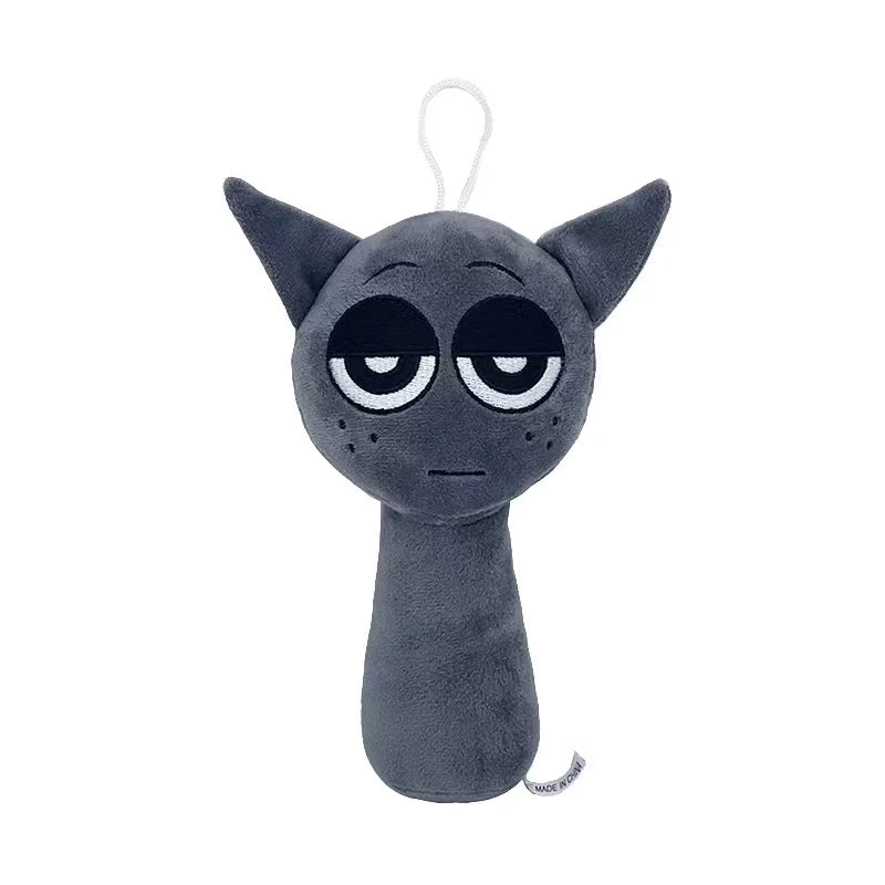 A dark gray collectible plush toy with large, sad eyes and a simple shape.