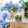A backdrop of blue and white balloons decorated with gold accents for a party