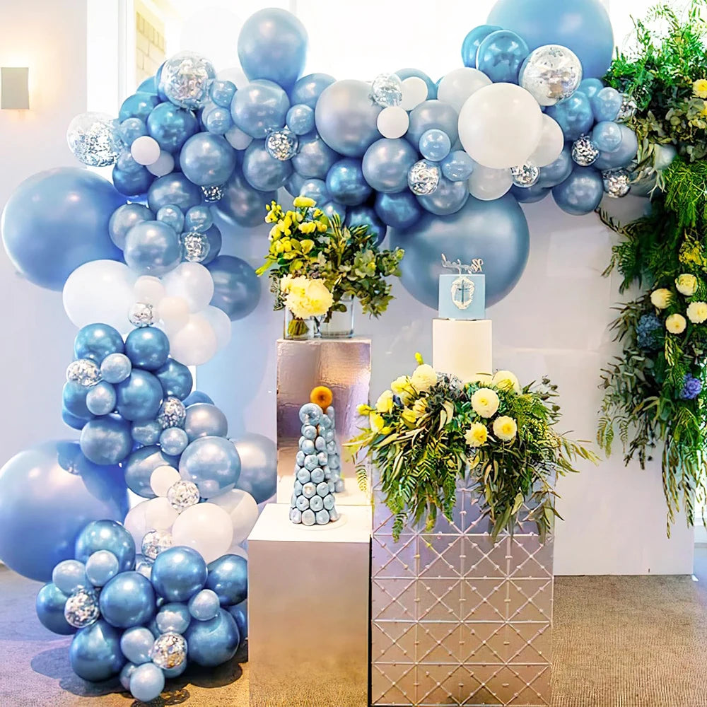 A backdrop of blue and white balloons decorated with gold accents for a party