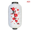 White paper hanging lantern decorated with red blossoms and branches