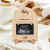 A wooden pregnancy announcement photo frame featuring an ultrasound image and the word Baby
