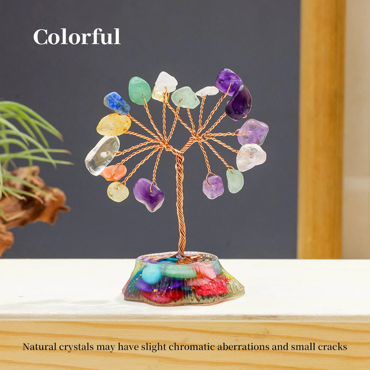 A colorful crystal tree featuring various natural stones arranged on a stand.