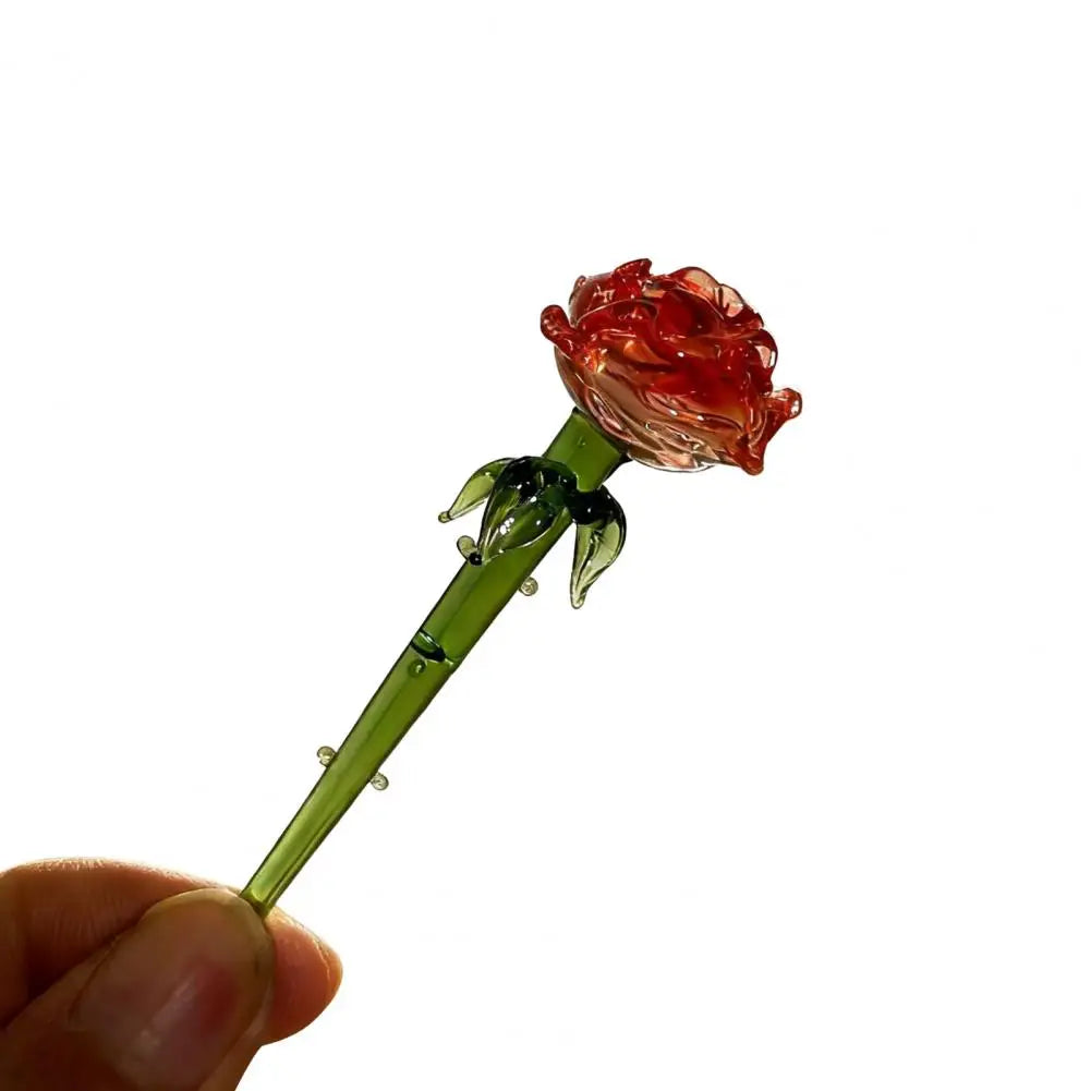 Handcrafted blue glass flower sculpture with a reddish-orange rose bloom on a green stem