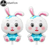 Two white bunny foil balloons with pink ears and blue accents
