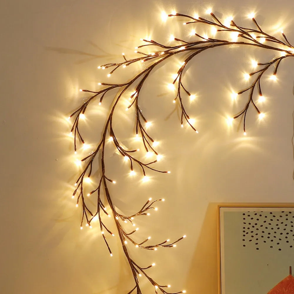 Willow branch string lights with remote control arranged in an arc against a light wall.