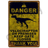A vintage metal sign with a yellow background and black text warning about a Velociraptor on premises.