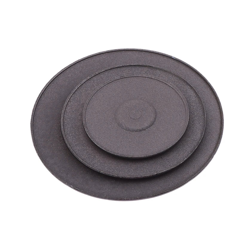 A set of three round, dark gray gas stove burner caps.