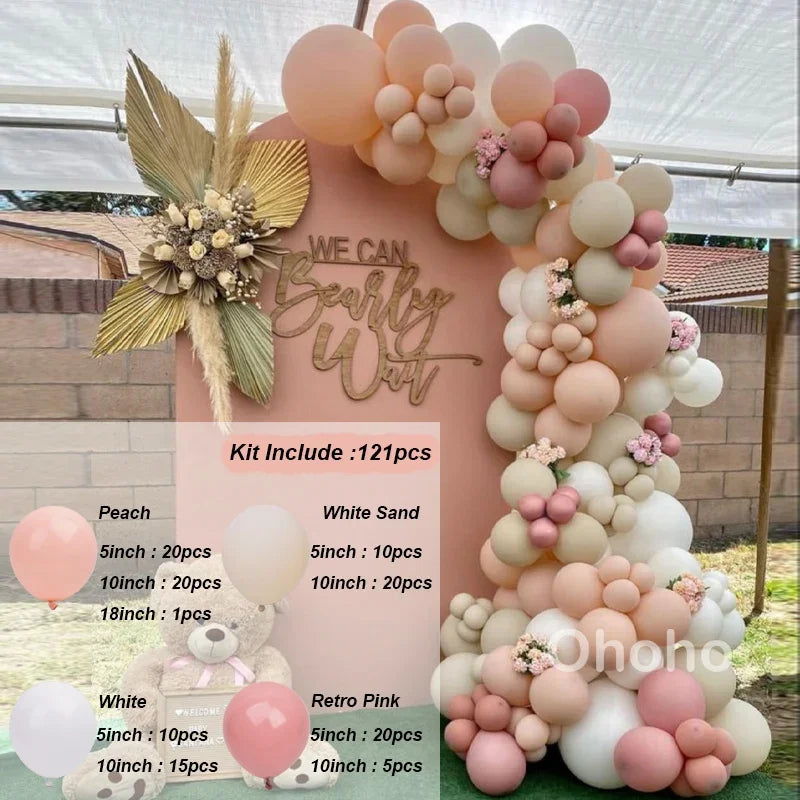 A pink and beige balloon garland arch kit featuring various sized balloons arranged in a floral design.