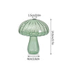 Vase décoratif en verre vert clair en forme de champignon avec un large chapeau et un long col.