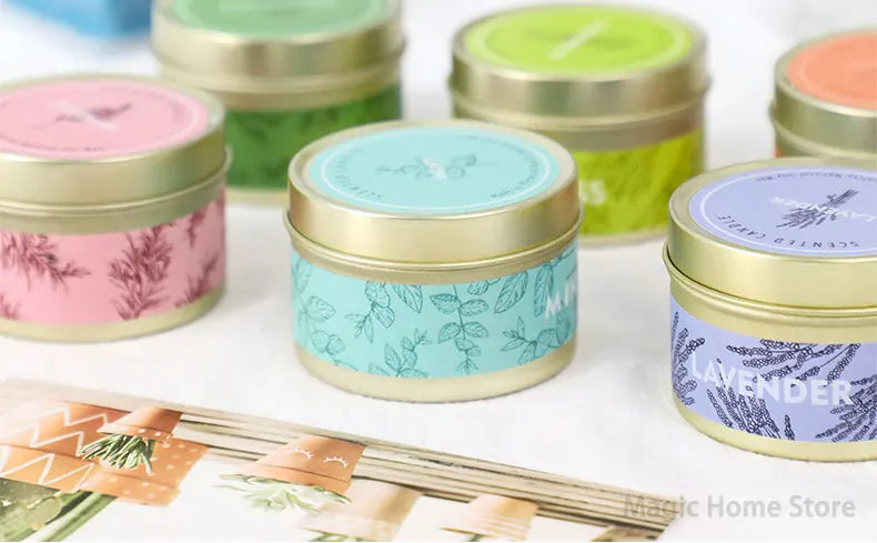 A collection of natural soy wax travel candles in various colors and designs, including pink, mint green, and lavender.