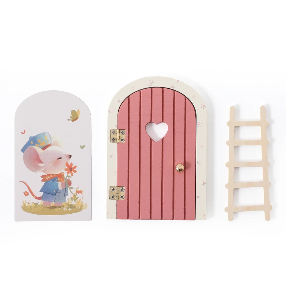 A miniature wooden fairy elf door decoration with a heart cutout and tooth box details.