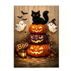 A black cat sits atop a stack of carved pumpkins surrounded by bats and ghostly figures on a wooden background.