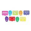 A collection of colorful decorative felt flags shaped like skulls for party decorations