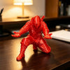 A red 3D ninja figure desk organizer is displayed on a dark wooden surface.