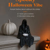 A black resin ghost figure with draped fabric sits on a mantelpiece next to a small white teacup.