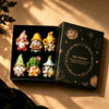 A set of Halloween witch mini dwarf resin figurines in a black box with gold accents.