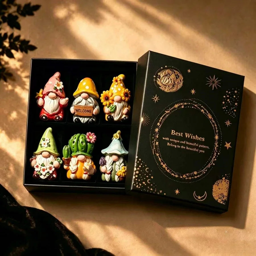A set of Halloween witch mini dwarf resin figurines in a black box with gold accents