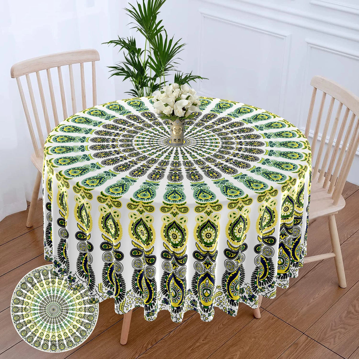 Bohemian peacock mandala round tablecloth displayed on a wooden table with a chair in the background.