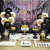 Elegant black and gold glitter birthday banner with cake decorations and treats