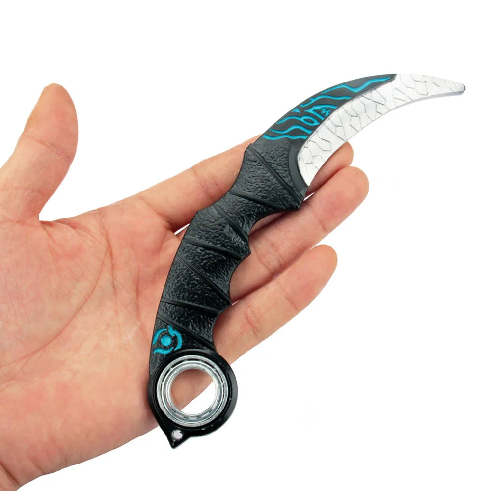 A hand holds an anime-style blue dragon rotating claw knife model with a black handle and white blade.