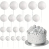 A display of twenty white foam ball cake toppers on individual sticks arranged above a silver cake plate.