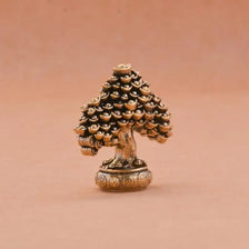 A brass fortune tree ornament featuring a detailed pinecone shape with ingot accents.