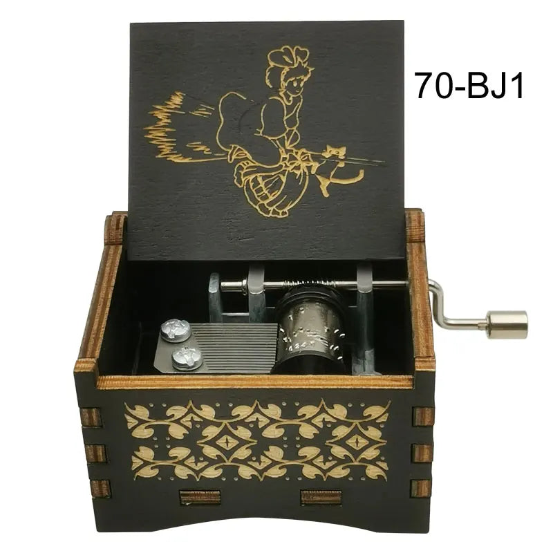 A black wooden music box with a lid featuring an anime character and a silver key.