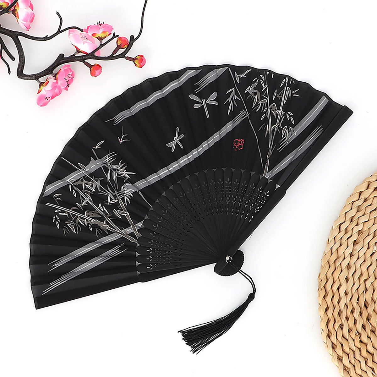 Black vintage bamboo folding fan with gray line patterns and pink floral accents