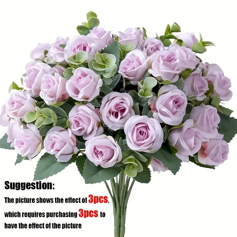 A bouquet of light pink silk roses and green eucalyptus leaves for wedding or home decor.