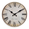 A round wooden wall clock with Roman numerals and black hands set against a distressed beige background.