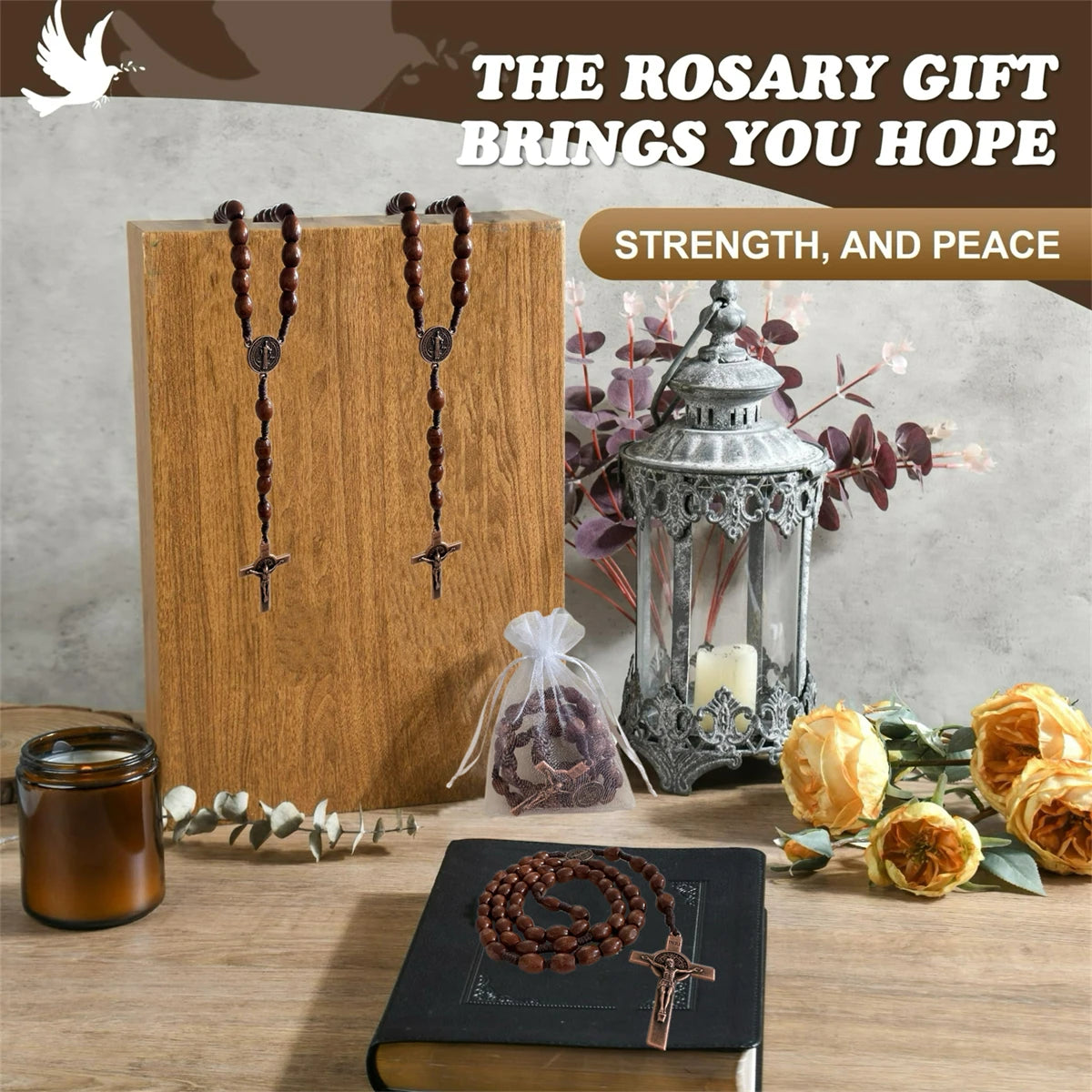 A wooden rosary pendant necklace with handcrafted beads rests on a book and next to an antique lantern.