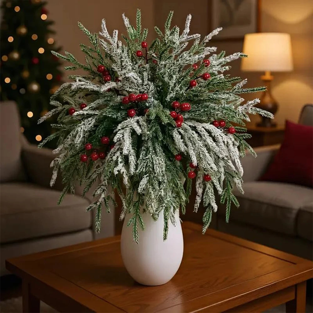 Artificial Norfolk pine branches with white flocked needles and red berry stems for holiday decor