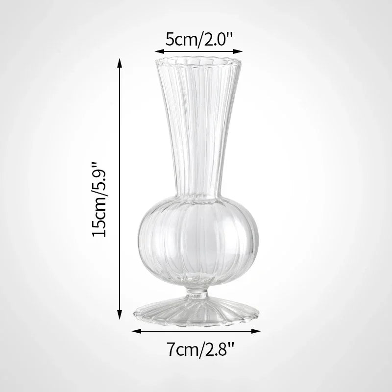 A clear glass vase with a flared neck and a rounded base, shown in a side profile.