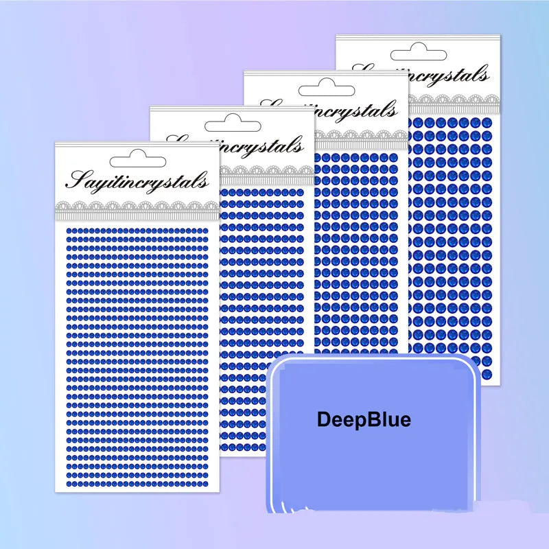 A collection of clear and blue self-adhesive rhinestone embellishments in various sizes and patterns.