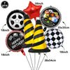 A set of seven balloons including a red star, a black and silver tire, a happy birthday sign, and several yellow and black st