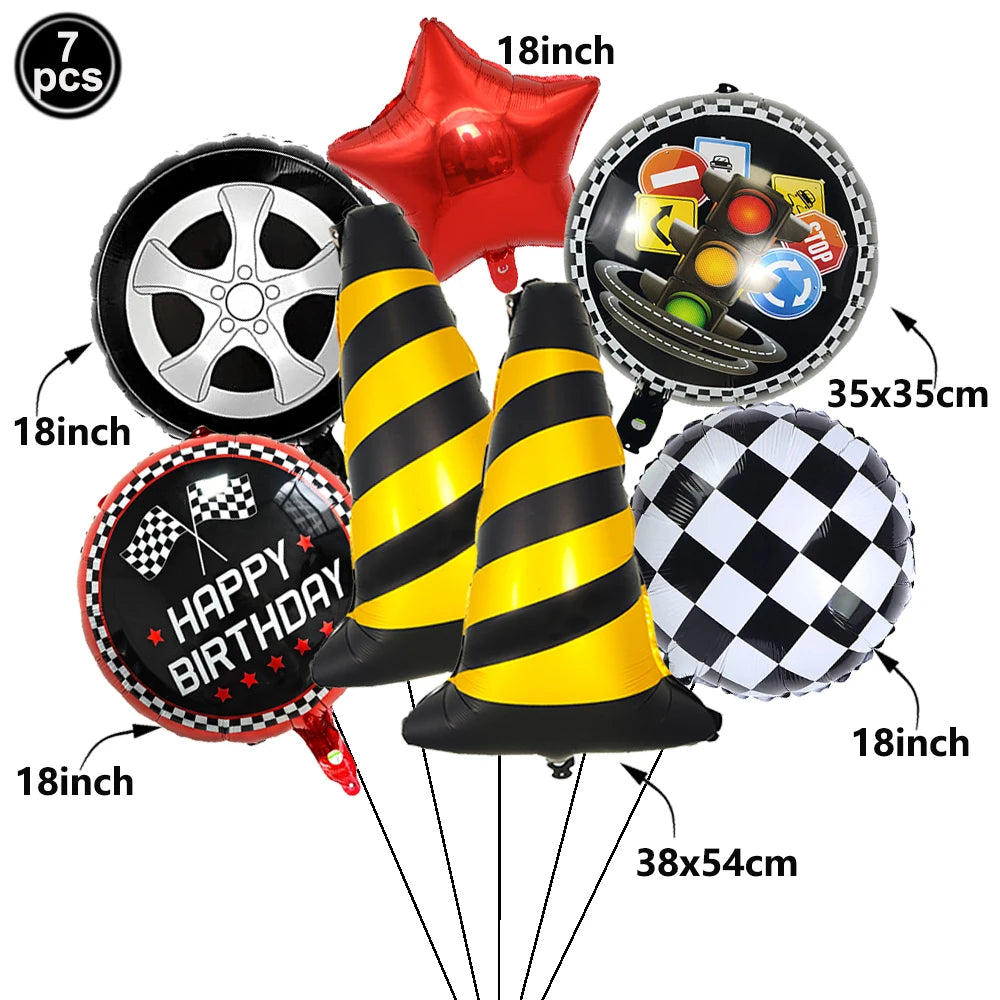 A set of seven balloons including a red star, a black and silver tire, a happy birthday sign, and several yellow and black st