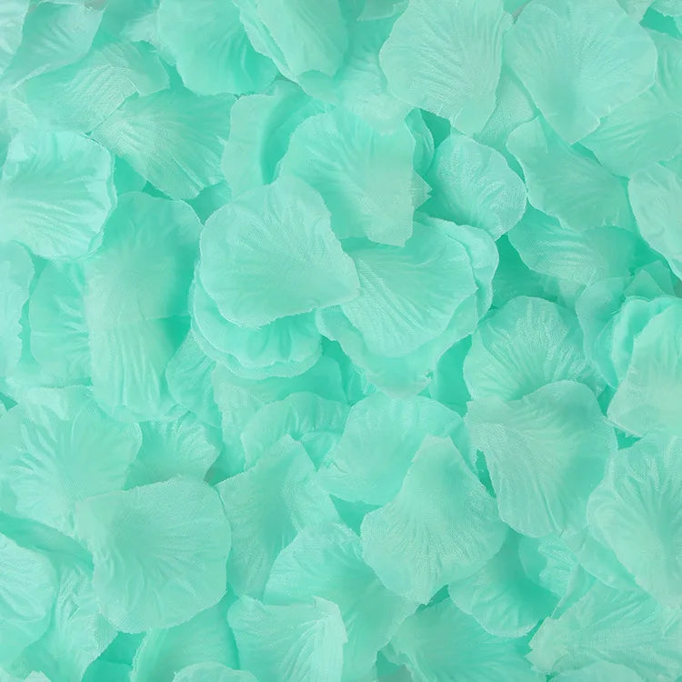 A pile of light mint green artificial silk rose petals for events.