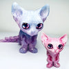 A pair of articulated 3D printed figurines depicting a purple and pink Siamese cat with iridescent eyes.