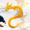 A golden, flexible dragon figurine is shown coiled in a dynamic pose against a light background with clouds.
